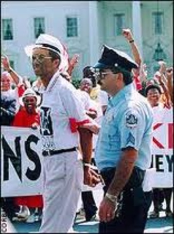 Ashe is arrested outside the White House for protesting the punishment of Haitian refugees by the U.S. government.