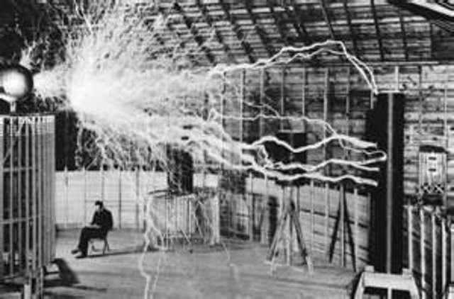 Nikola Tesla makes a device to produce and transmit high-frequency electricity