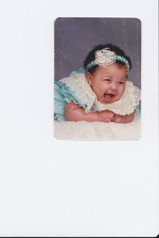 A baby can hold its head up and reach for objects.