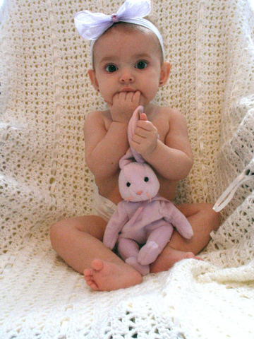 A baby can hold its head up and reach for objects.