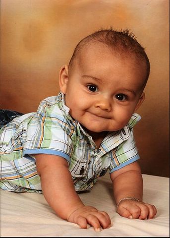 Infant begins to crawl.