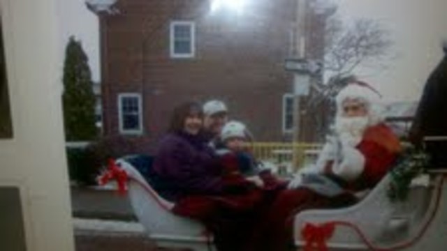 James riding a sleigh with Santa