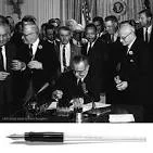 The Civil Rights Act of 1964 signed by President Johnson