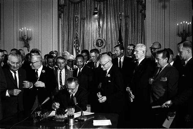The Civil Rights Act of 1964 signed by President Johnson