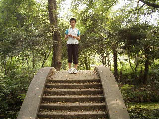 Cute girl standing on a small bridge