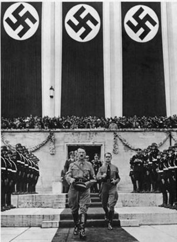 Hitler builds up army, violates Versailles Treaty