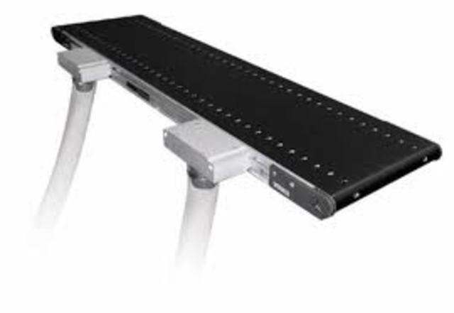 A conveyor belt is successfully installed in a Pennsylvania anthracite mine to carry coal to a string of cars at the mine entry.