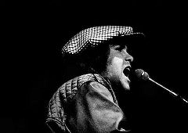 Elton John is seen without his trademark glasses