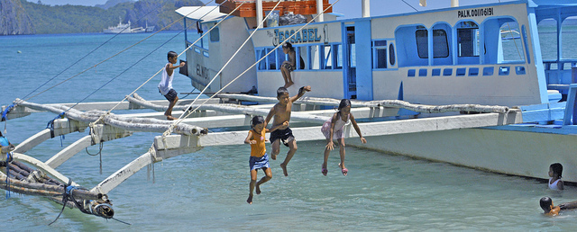 Phillip gets hit in the head with a piece of lumber, and jumps of the boat, and falls in the water
