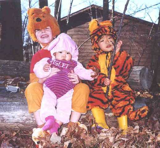 Me and my siblings  on a log at home in the fall