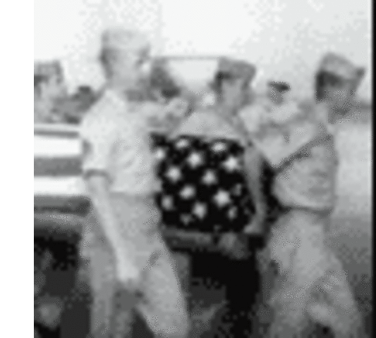 One of the American dead is carried to a waiting transport