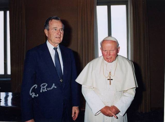 Meets with George H.W. Bush