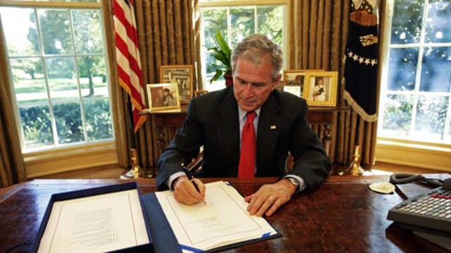 The $700 billion bailout bill for the US financial system is signed by President Bush.