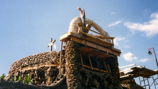 Roman arch and capstones added to top of Trinity Grotto