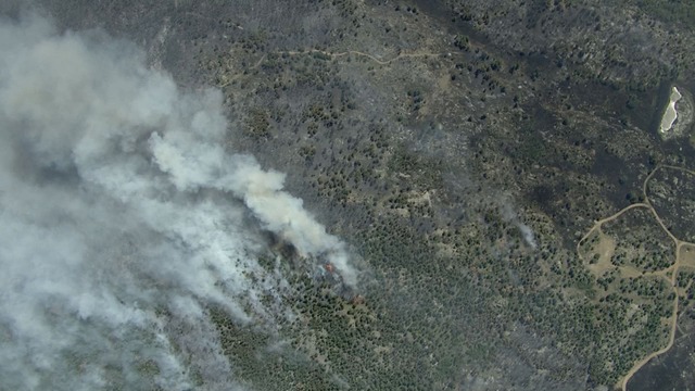 9:33 p.m. - Firefighters work to save a home