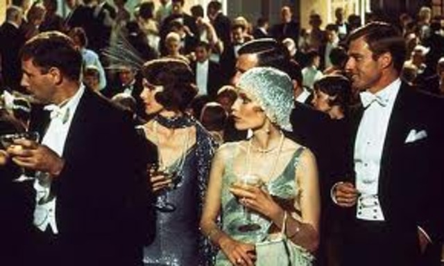 Gatsby throws a lavish party and invites Nick