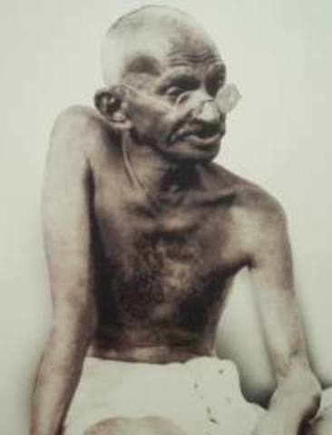 gandhi returns to india after 21 years of being a lawyer in south africa. he demonstrates by being passively resistant for  being mistreated by whites. he begins a fast and attracks alot of attention