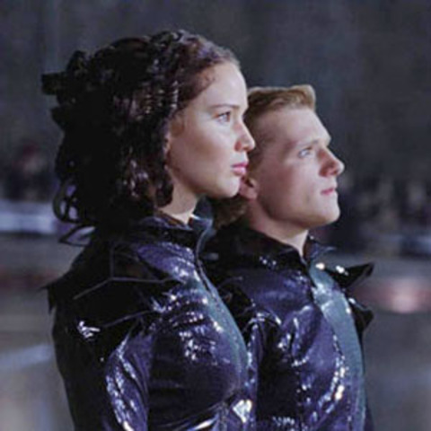 Katniss is brought to district 13 in a hovercraft by the people in district 13 because they want her to be their mocking jay.