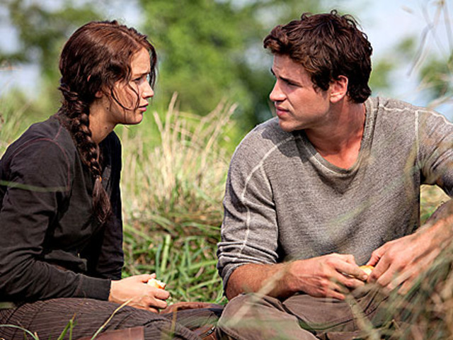 Katniss confronts Gale that the wedding is all made up and Gale is beaten in the square and katniss saves him by throwing her body over him.