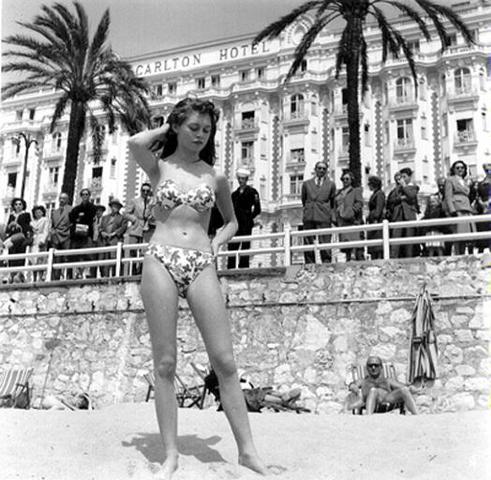 Brigitte Bardot causess a scandal at the Cannes Film Festival by wearing a bikini
