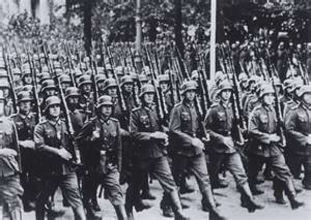 German troops march into the demilitarized Rhineland.