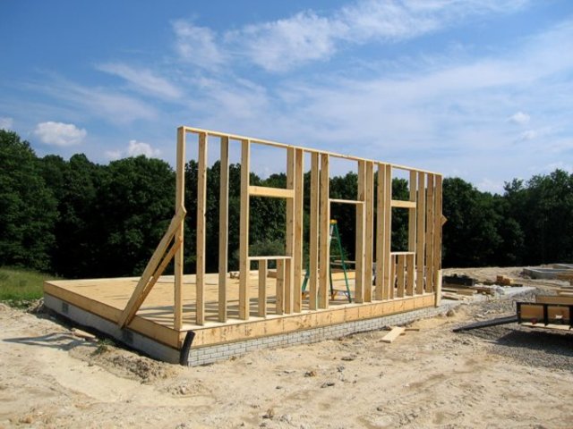 Setting walls up on the house.