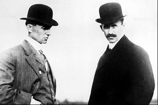 Orville and Wilbur Wright fly the airplane.