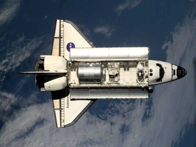 Discovery becomes first shuttle docked at ISS