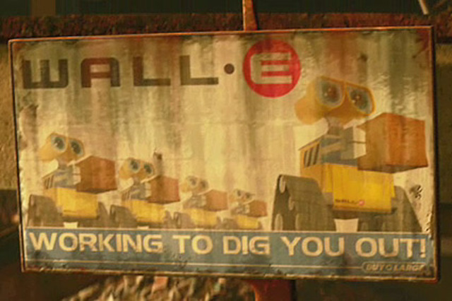 WALL-E heads to his "home", going past expository billboards and buildings.
