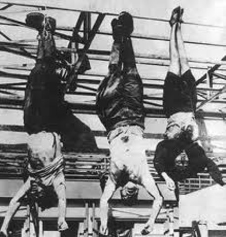 Mussolini is captured and hanged upsidedown by Italian partisans.