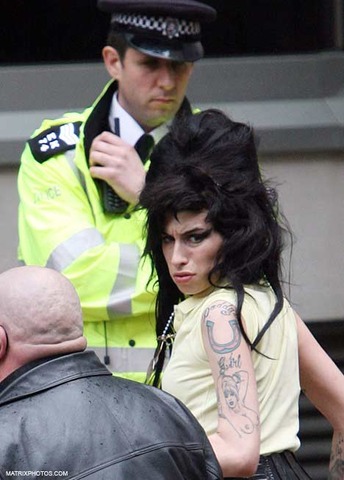 Winehouse pleads guilty to boozily assaulting a theater manage.