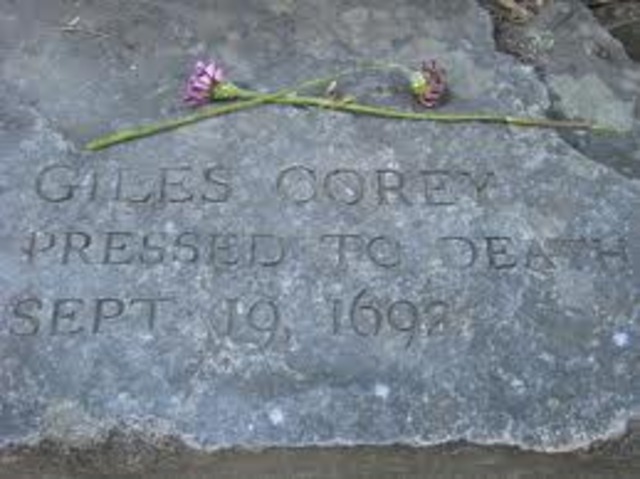 Giles Corey is pressed to death after being found guilty of witch craft.