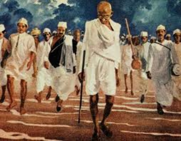 Gandhi leads a peaceful march in protest of a racist poll tax and marriage laws