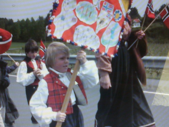 Norway's national day, thomas is walking with his school (Kirkeskolen) in a parade around Ringåsen (where he lived in Norway)