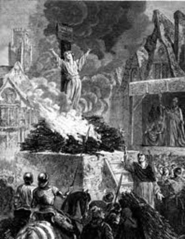 Joan of Arc is burned at the stake as a heretic