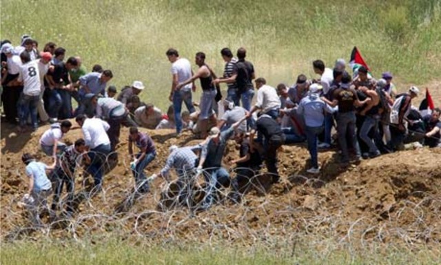 Israeli troops clash on Syrian border with protesters