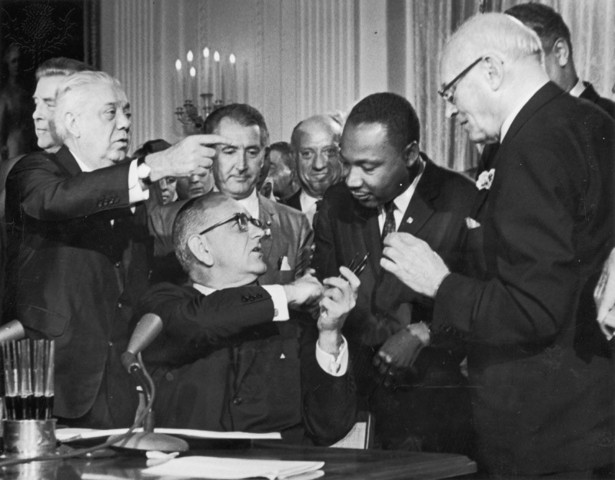 Pres. Lyndon Johnson signs the Civil Rights Act