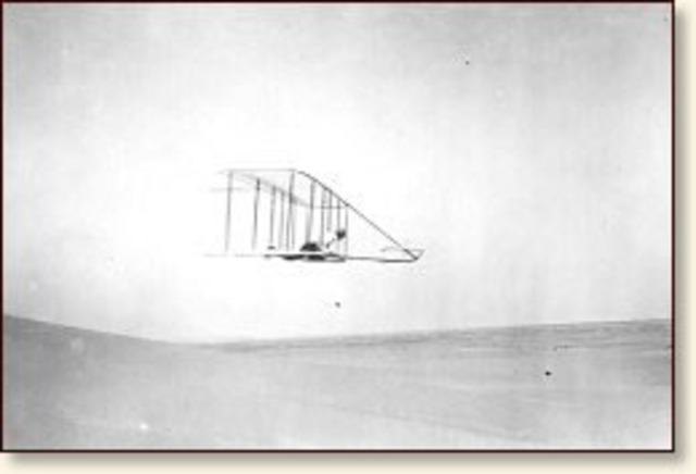The wright brothers fly the first motor-driven airplane