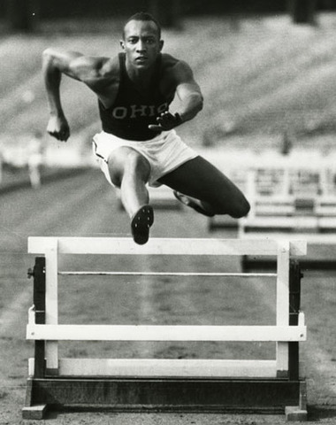 Jesse Owens wins four gold medals at Berlin Olympics