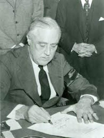 Roosevelt signs Lend-Lease Act.