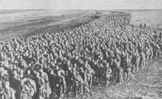 Hitler violates the Versailles Treaty by renewing the compulsory military draft.