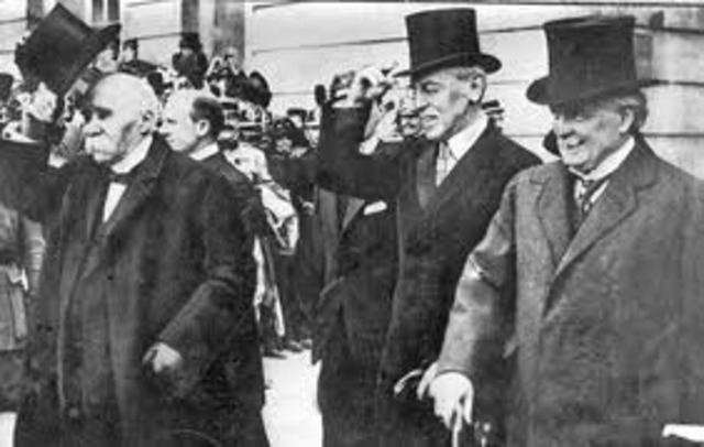 Hitler violates the Versailles Treaty by renewing the compulsory military draft.