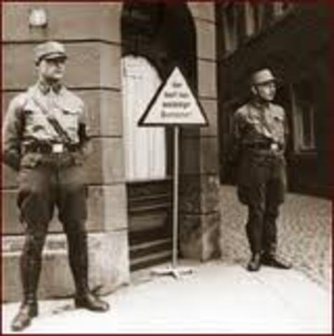 "No Jews" signs and notices are posted outside German towns and villages, and outside shops and restaurants.