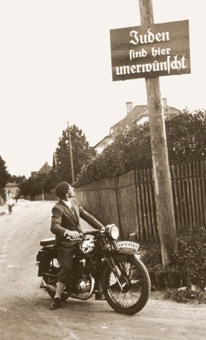 "No Jews" signs and notices are posted outside German towns and villages, and outside shops and restaurants.