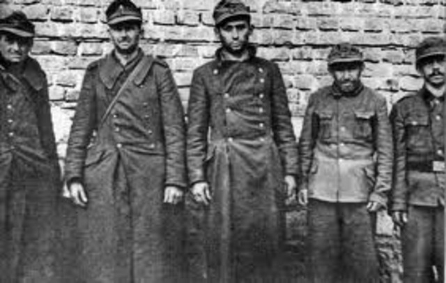 Hitler violates the Versailles Treaty by renewing the compulsory military draft.