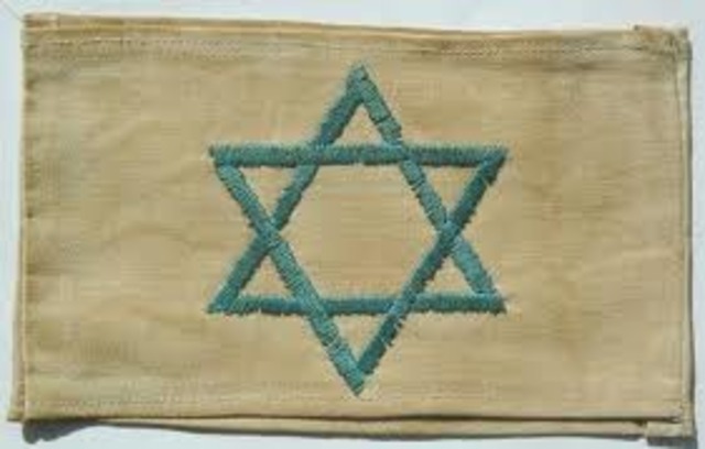 German Jews above the age of six are forced to wear a yellow Star of David sewed on the left side of their clothes with the word "Jude" printed in black.