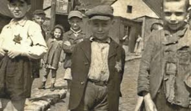 German Jews above the age of six are forced to wear a yellow Star of David sewed on the left side of their clothes with the word "Jude" printed in black.