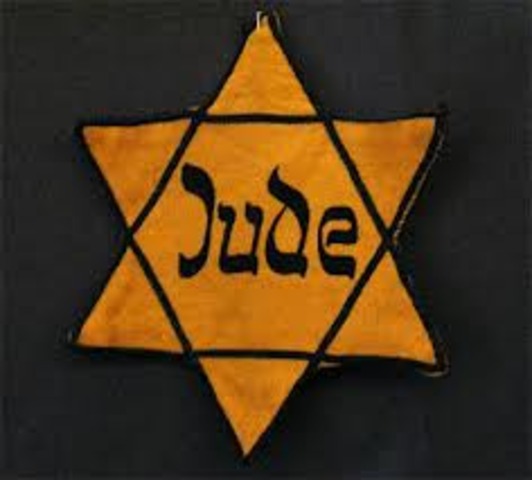 German Jews above the age of six are forced to wear a yellow Star of David sewed on the left side of their clothes with the word "Jude" printed in black.