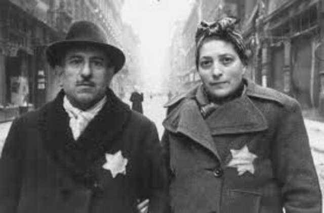 German Jews above the age of six are forced to wear a yellow Star of David sewed on the left side of their clothes with the word "Jude" printed in black.