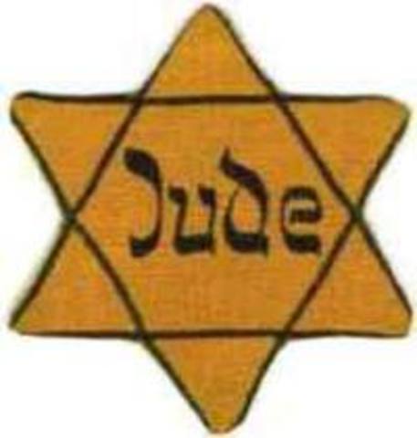 German Jews above the age of six are forced to wear a yellow Star of David sewed on the left side of their clothes with the word "Jude" printed in black